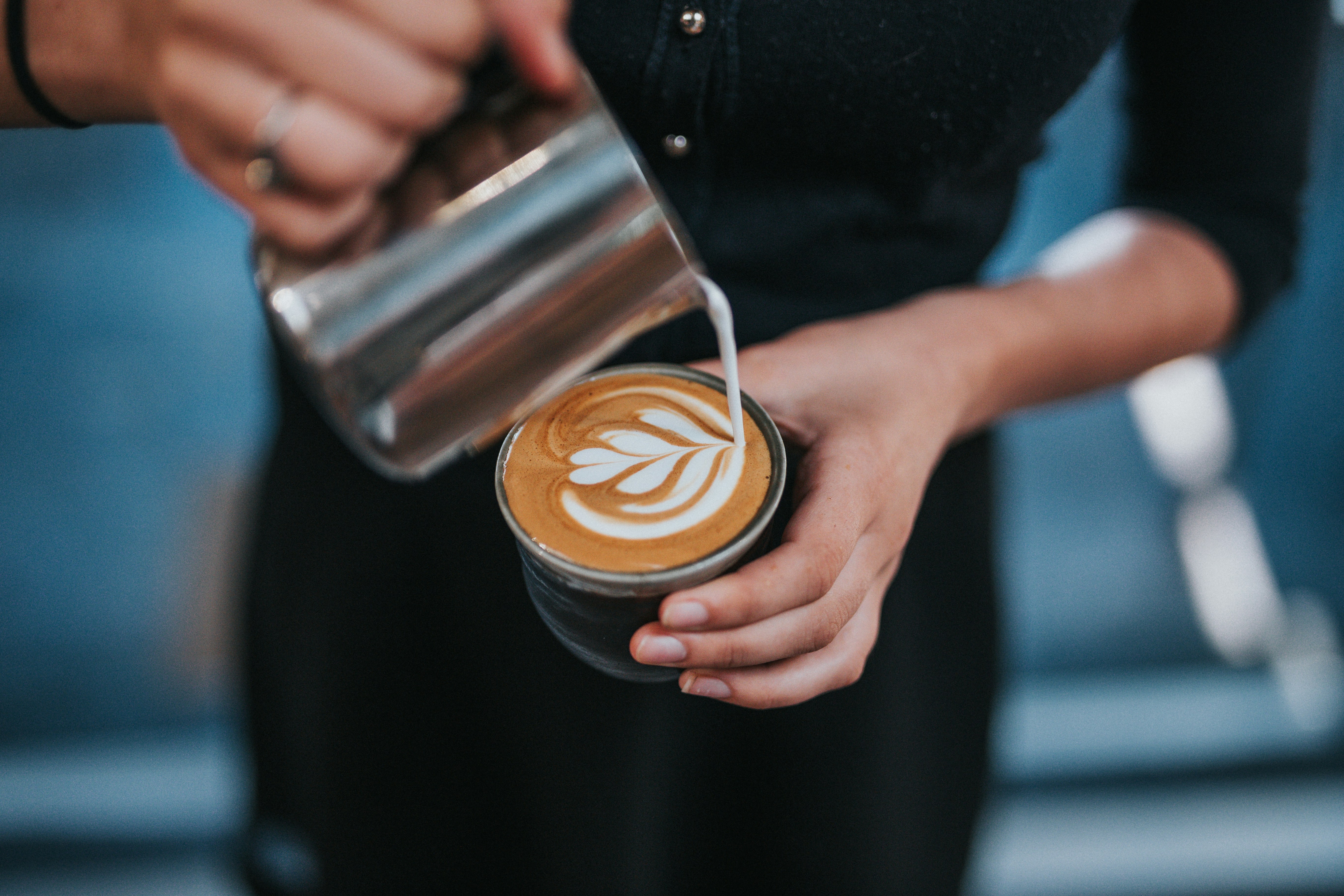 a barista making latte art in coffee